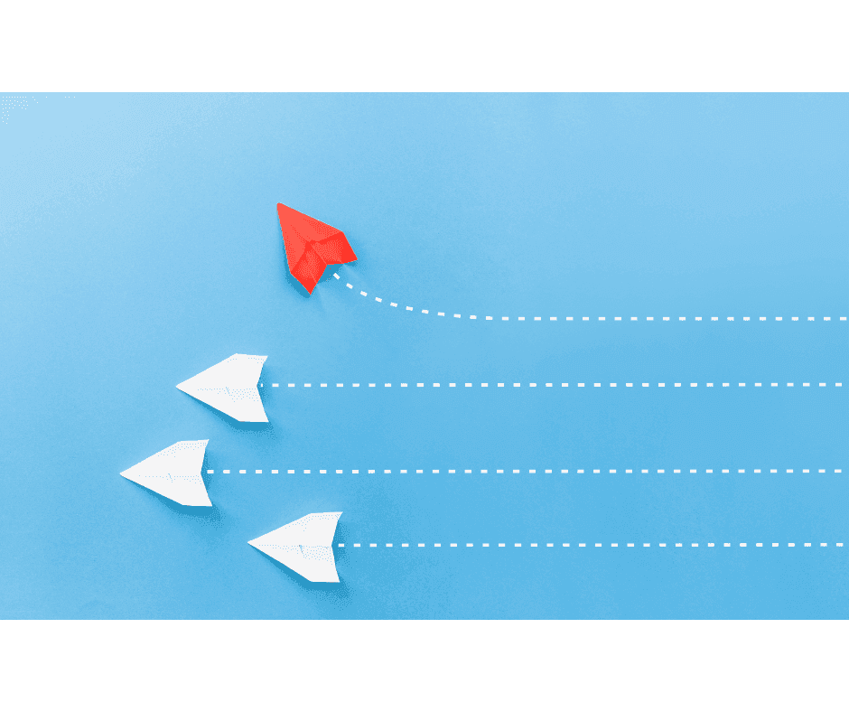 A red paper airplane diverges from several white paper airplanes, representing the optimal SaaS revenue recognition tool.